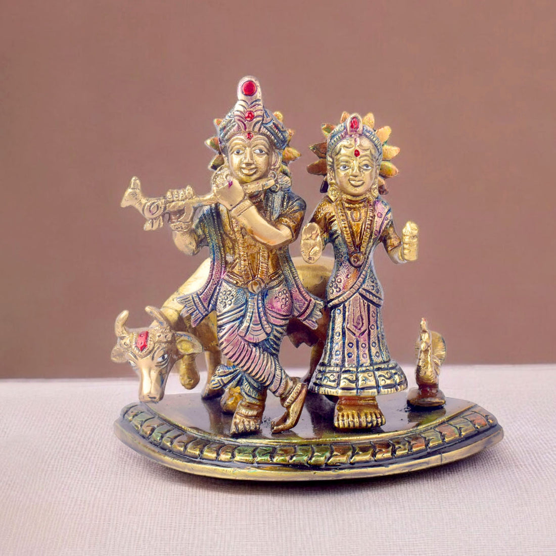 The 5.5 Inch Divine Radha Krishna with Kamdhenu Cow Idol is a captivating symbol of eternal love, harmony, and divine blessings. This beautifully crafted idol features Radha and Krishna in a serene pose, with Krishna playing his mesmerizing flute and Radha standing gracefully by his side.