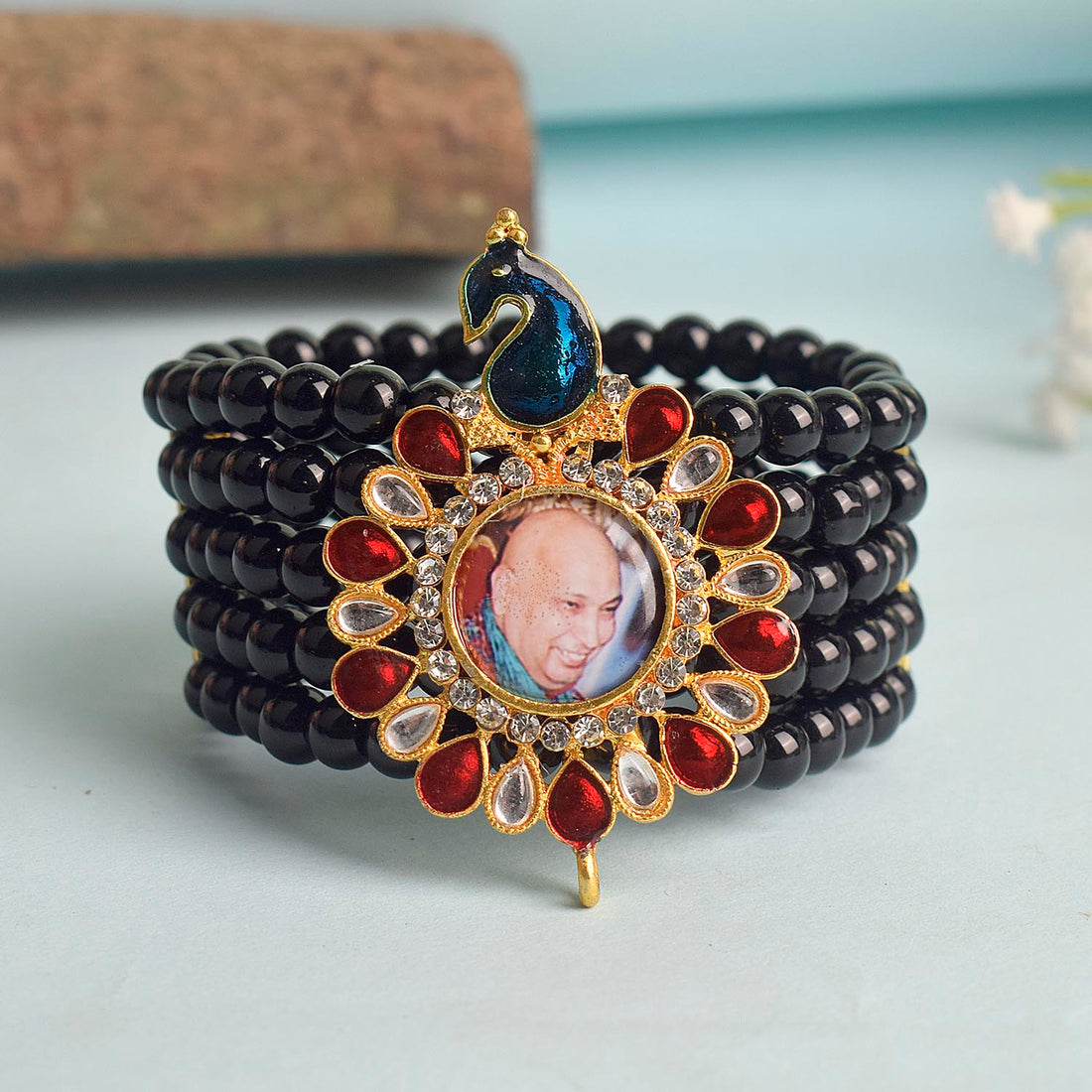 Black Beads Five Layer Guruji Swaroop Bracelet featuring a regal peacock-shaped pendant with Jai Guruji Swaroop – perfect for spiritual wear, meditation, and gifting. India’s Largest Pooja Accessories Brand – www.satvikstore.in