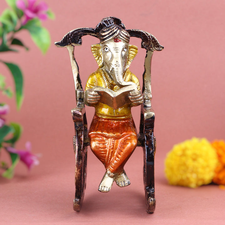 4.5 Inch Pure Brass Reading Book Ganesha Statue, beautifully crafted with intricate details of Lord Ganesha engrossed in reading, symbolizing wisdom, knowledge, and learning – ideal for study rooms. No.1 Brass Idol Store www.satvikstore.in