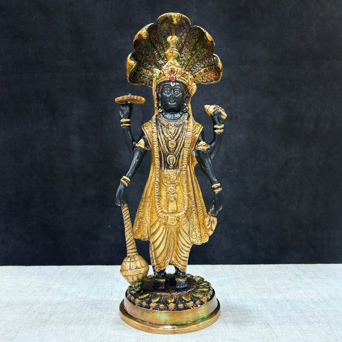This elegant brass statue of Lord Vishnu seated on the mighty Seshnag is a powerful symbol of divine protection, balance, and cosmic order. The intricate craftsmanship beautifully depicts Lord Vishnu in his serene and majestic form, with the multi-headed Seshnag providing a protective canopy. India's Largest Puja Accessories Brand - Satvik No. 1 Brass Idol Collection