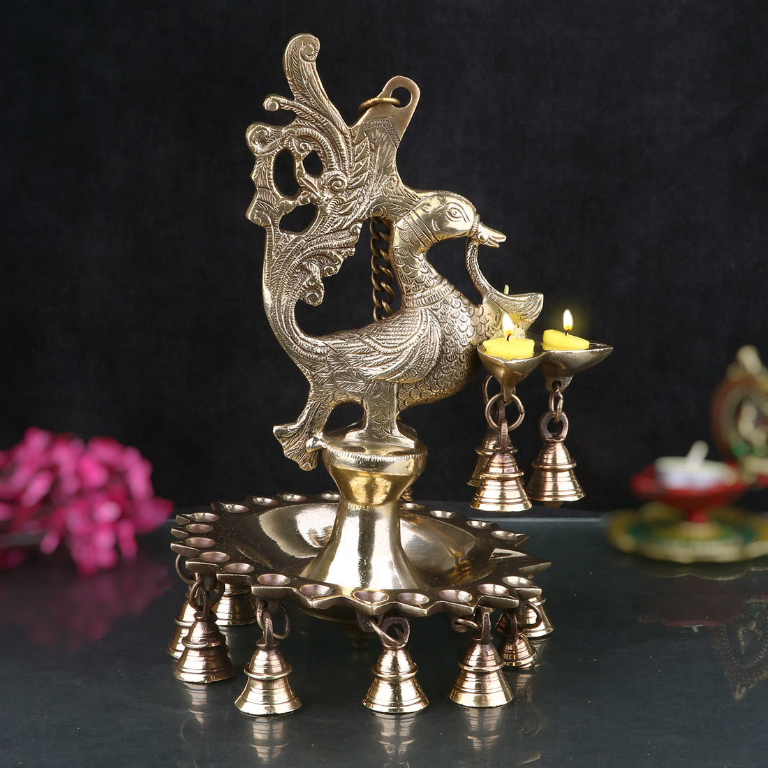 A stunning Brass Peacock Diya Hanging with Bells, featuring a graceful peacock design with a shiny brass finish. India’s Largest Pooja Accessories Brand – www.satvikstore.in