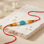 Handcrafted Turquoise Carved Om Symbol Flower Motif Rakhi
