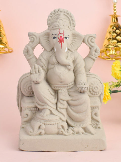 7 Inch Lord Ganesha idol seated majestically on a decorative Shinghasan, crafted in eco-friendly material with intricate detailing. India’s Largest Pooja Accessories Brand – www.satvikstore.in