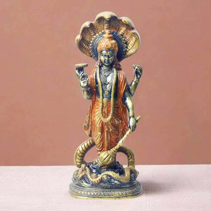  Bring divine protection and blessings into your home with this stunning 17-inch Brass Vishnu Standing with Sheshanag Idol. This intricately crafted statue features Lord Vishnu, the preserver of the universe, standing gracefully atop the Sheshanag (cosmic serpent). 