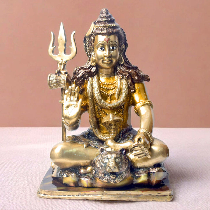 Embodying peace and spiritual focus, this 17.5-inch Brass Shiva Idol features Lord Shiva in a serene meditative posture. Known as the ultimate yogi, Lord Shiva is beautifully represented here with intricate detailing in brass, capturing the tranquility and profound wisdom of his meditation.