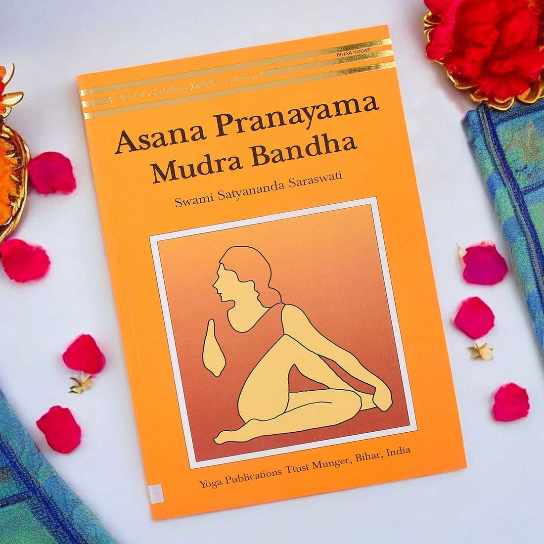Front cover of the "Asana Pranayama Mudra Bandha – Golden Jubilee Edition" paperback, a comprehensive guide to yogic practices by Bihar School of Yoga. India’s Largest Pooja Accessories Brand – www.satvikstore.in