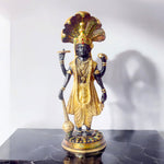  This elegant brass statue of Lord Vishnu seated on the mighty Seshnag is a powerful symbol of divine protection, balance, and cosmic order. The intricate craftsmanship beautifully depicts Lord Vishnu in his serene and majestic form, with the multi-headed Seshnag providing a protective canopy. 