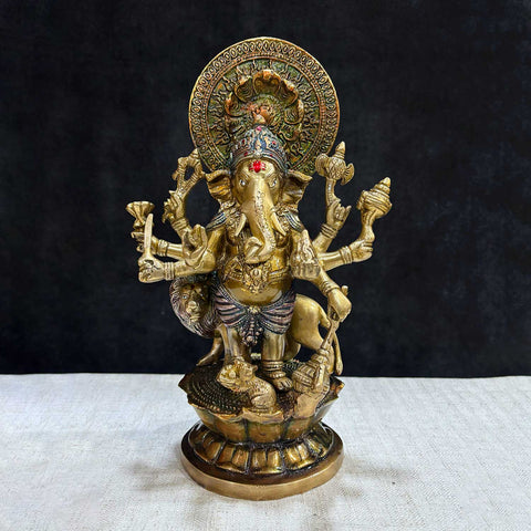 The "11.6 Inch Ganesh Idol" is a majestic and detailed representation of Lord Ganesha, embodying divine presence, prosperity, and new beginnings. Standing at 11.6 inches tall, this idol features intricate craftsmanship, capturing Ganesha’s serene expression and symbolic attributes, including his axe, lotus, and modak.