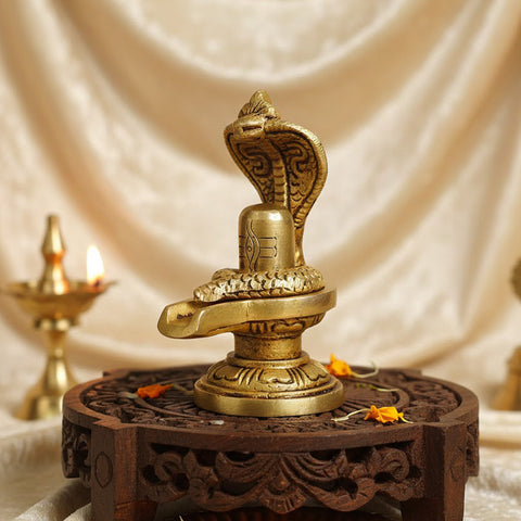 Elegant Brass Shivling with coiled Nag, symbolizing spiritual energy and protection, perfect for home worship and meditation. India’s Largest Pooja Accessories Brand – www.satvikstore.in